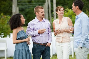 People socialising at outdoor dinner party